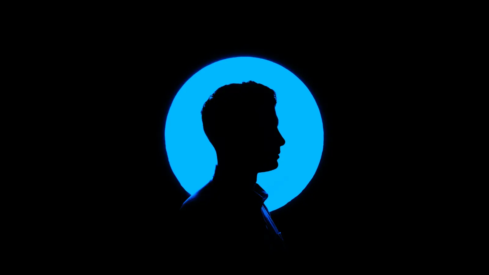 A human profile silhouetted against a blue circle
